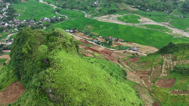 Village Below Forested Karst Hill