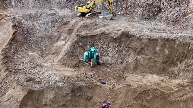 Excavators Working Stepped Rock Face
