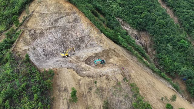Excavators Carving Forested Peak Road