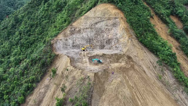Excavators Above Forested Valley