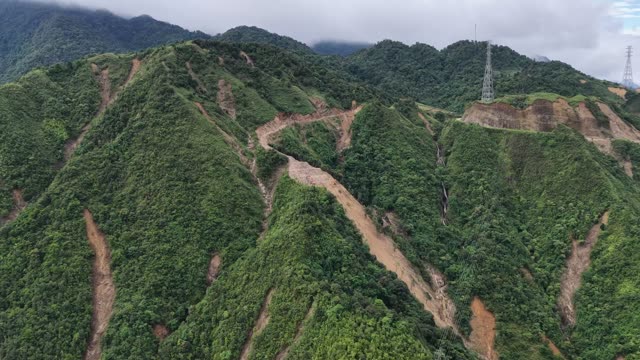 Excavator On Steep Mountain Ridge