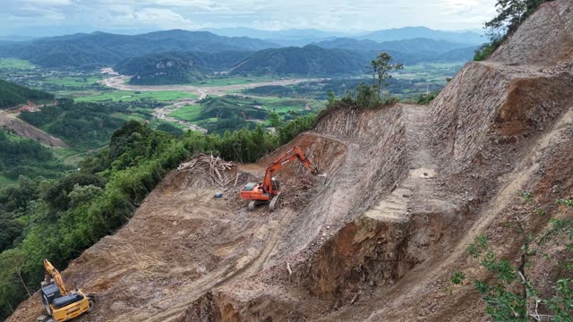 Two Excavators On Mountain Road