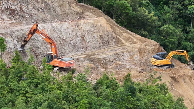 Two Excavators On Mountain Slope