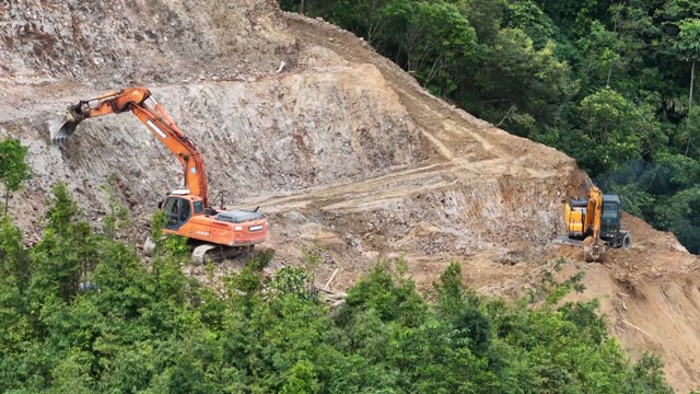 Excavators Clearing Rocky Cliff