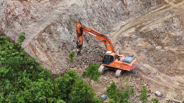 Excavator Digging Rocky Mountain Wall