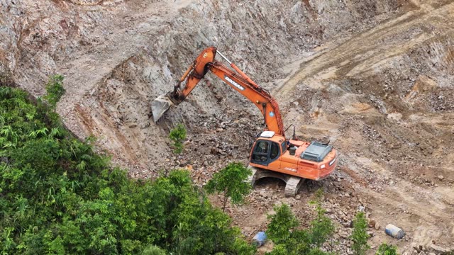 Excavator Carving Steep Rock Face