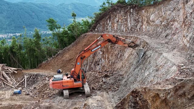 Excavator On Steep Rocky Slope