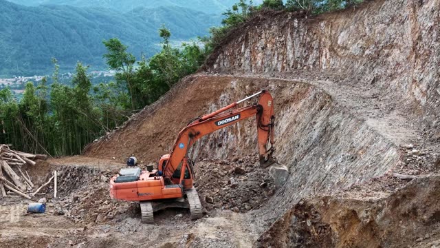 Excavator Digging Mountain Roadside