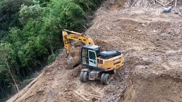 Yellow Excavator On Mountain Peak