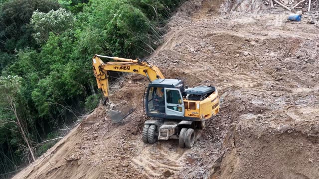 Excavator Clearing Peak Road Cut