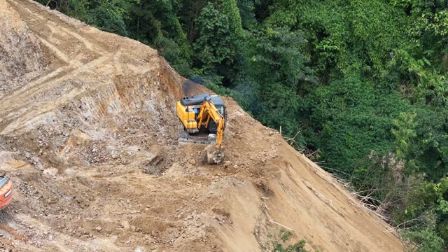 Excavators Above Terraced Valley