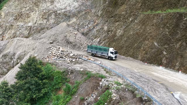 Truck Beside Waterfall On Mountain Road