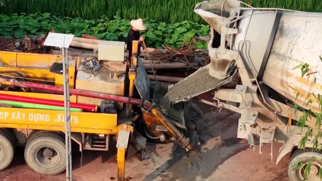 Worker At Concrete Mixer Chute