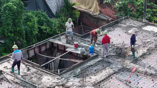 Workers Spreading Wet Concrete