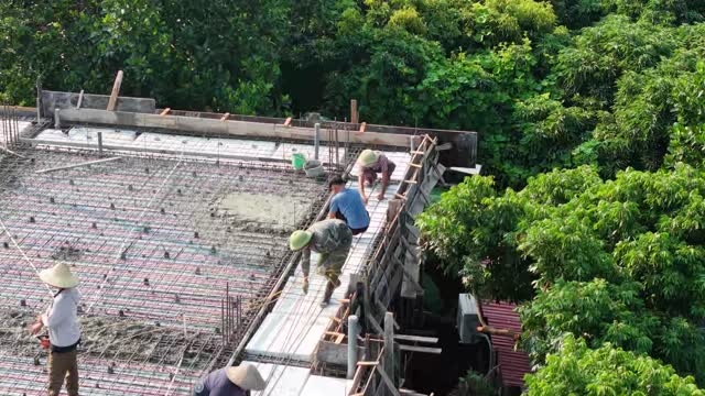 Workers On Roof Edge