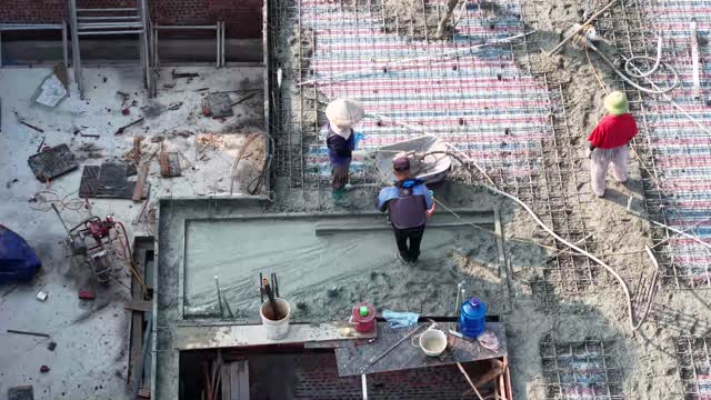 Workers Screeding Roof Edge