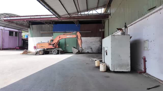 Excavator Inside Steel Frame Shed