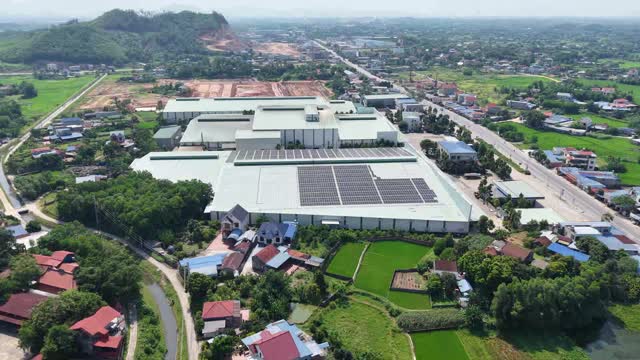 Aerial Factory Among Rice Fields