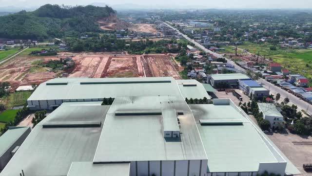 Factory Rooftops Over Village