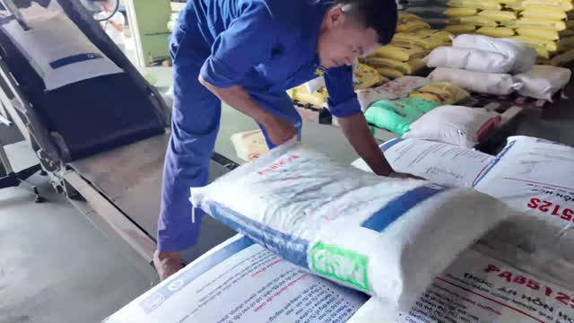 Worker Handling Feed Sack