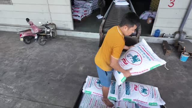 Worker Carrying Feed Sack