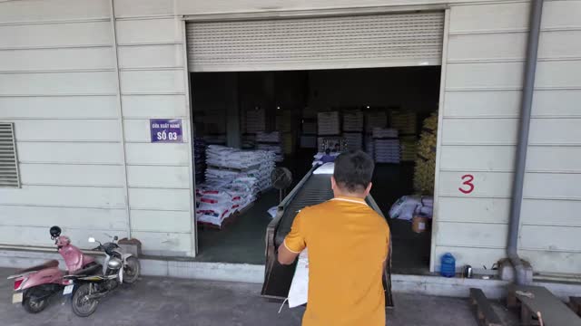 Worker Carrying Sack At Warehouse