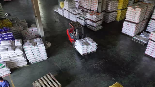 Forklift Moving Sacks In Warehouse