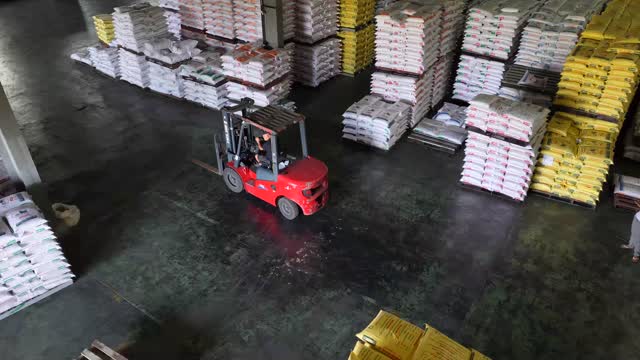 Forklift Among Stacked Feed Bags