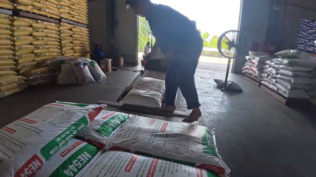 Worker Moving Feed Sacks