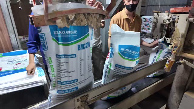 Workers Bagging Fertilizer Product