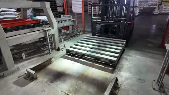 Forklift Handling Pallet In Warehouse