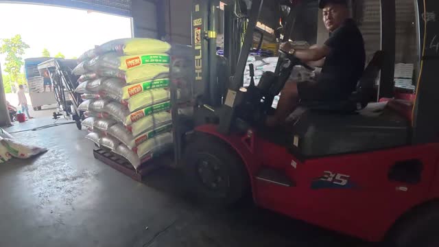 Forklift Driver Moving Feed Pallet