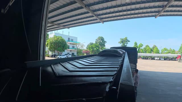 Loading Sacks Onto Truck Conveyor