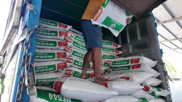 Worker Carrying Feed Sack