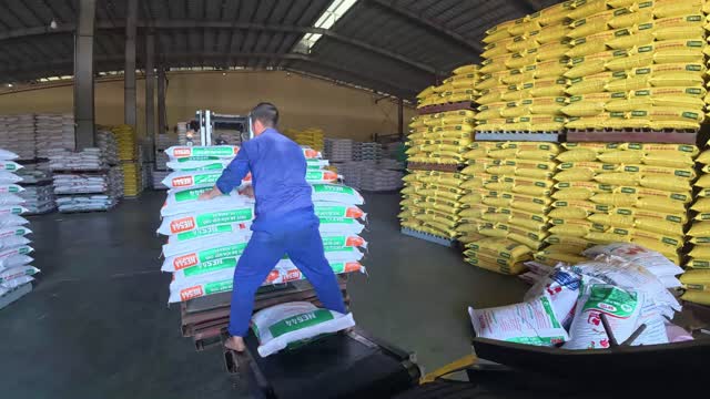 Worker Carrying Feed Bags