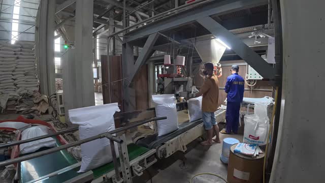 Workers Packing Feed Sacks Mill