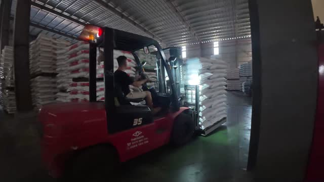 Forklift Carrying Feed Sacks