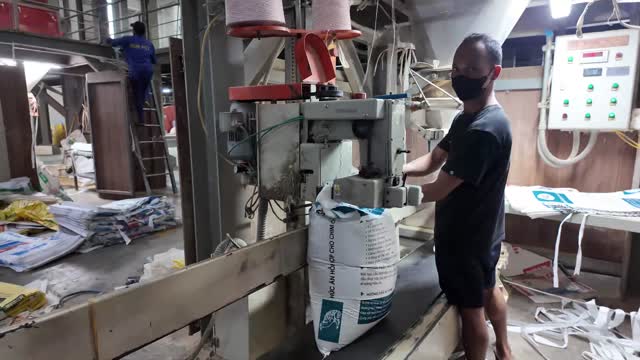 Worker Filling Feed Bag