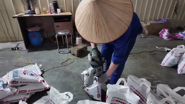 Worker Bagging Animal Feed