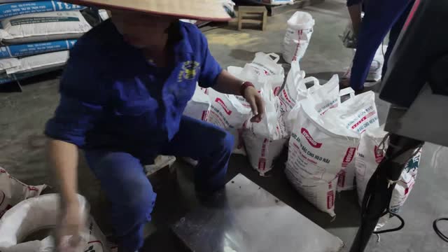Packing Livestock Feed By Hand
