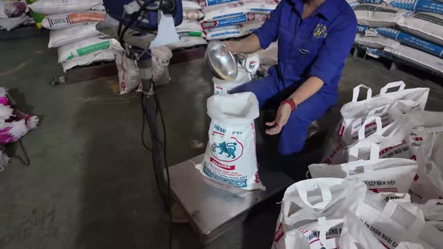Worker Filling Feed Bag
