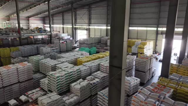 Workers In Feed Warehouse