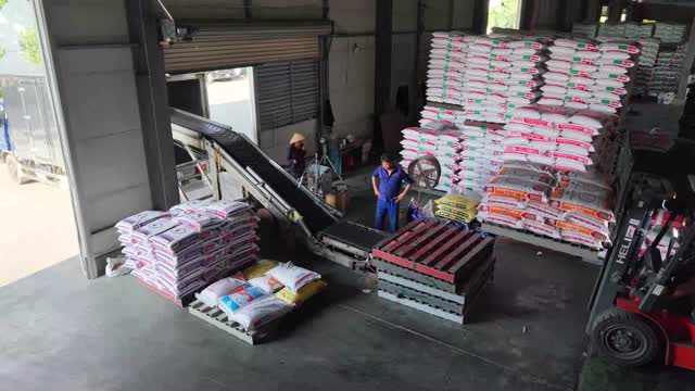 Workers Loading Feed Warehouse