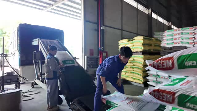Workers Loading Feed Bags