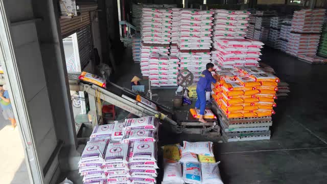 Worker Loading Feed Bags