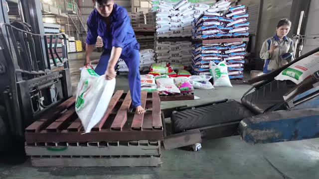 Loading Feed Bags On Pallet