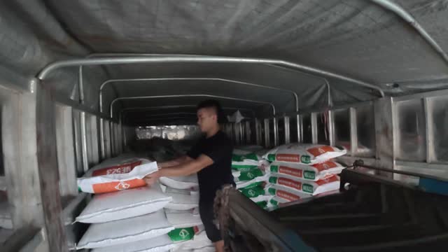 Loading Feed Sacks Into Truck