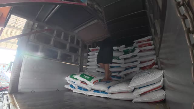 Filling Truck With Feed Sacks