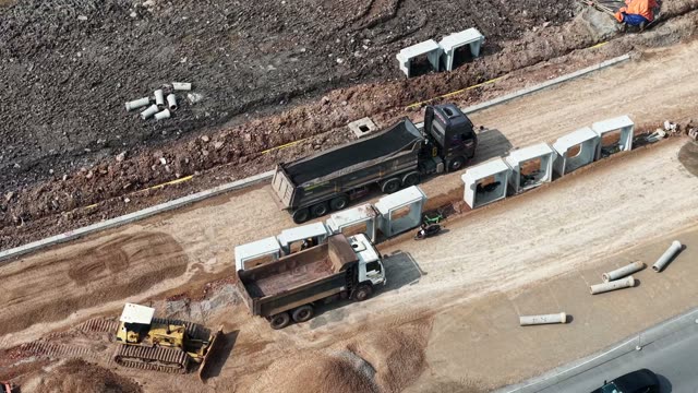 Trucks Along Culvert Line