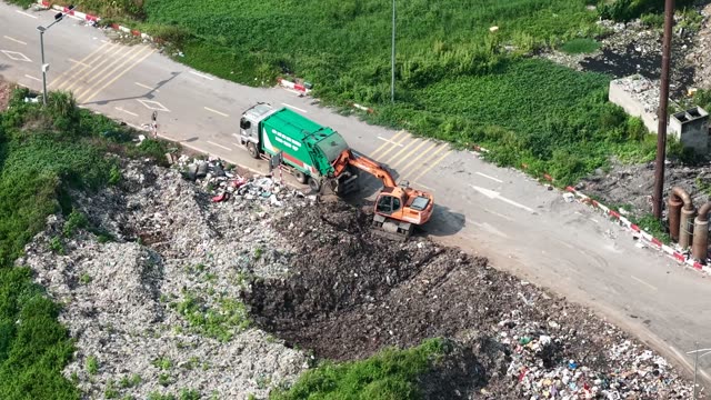Excavator Loading Garbage Truck